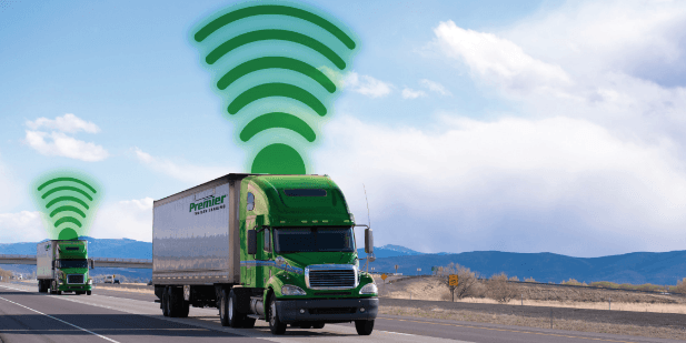 Two Premier trucks on the highway with wifi signals above each truck