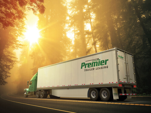 Premier truck driving on a sunny 
         day